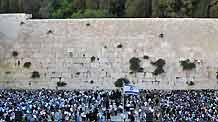 Demonstrators gather for a rally to denounce Israeli government's policy on Jewish settlements, at the Western Wall in Jerusalem's Old City on June 21, 2009. Israeli Prime Minister Benjamin Netanyahu vowed in a keynote speeck on June 14 that Israel would not build any new settlements and would refrain from expanding existing Israeli communities in the West Bank.