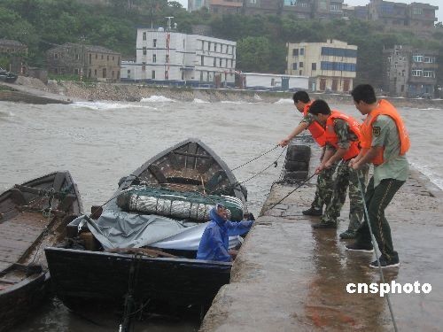 Rescue workers save a fisherman in Tannianggong, Fuzhou City. Torrential rain, strong winds and landslides triggered by tropical storm Linfa have left one dead and another six missing in east and south China provinces, local authorities said on June 22. 