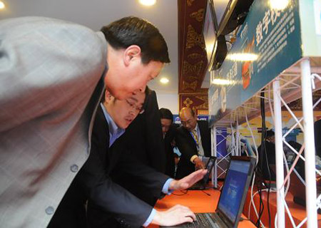 A staff from the Tibet Telecom of China Telecom demonstrates to a customer the 3G services provided by China Telecom in Lhasa, capital of southwest China's Tibet Autonomous Region, on Friday, on May 15, 2009. A Tibetan official said on Monday broadband internet service would be available to more than half of villages in southwest China's Tibet Autonomous Region within three years. 