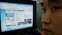 Photo taken on November 6, 2006 shows a young man from Medog County, southeastern Tibet's Nyingchi Prefecture, surfing on the Internet at an Internet bar.
