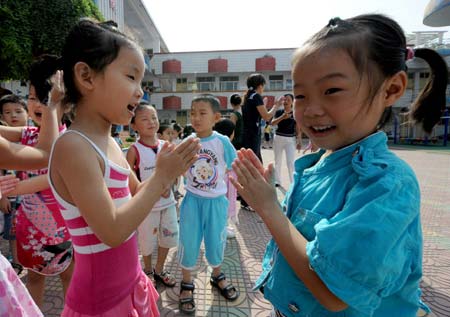 Kids of Zhoukou Experimental Kindergarten play with each others during break time in Zhoukou city, central China's Henan Province, on June 22, 2009. A total of 214 children showed symptoms of vomiting, diarrhea and identified as bacterial food poisoning. They were immediately sent to a nearby hospital, and most of them were recovered and discharged from the hospital. The Kindergarten resumed classes on Monday.