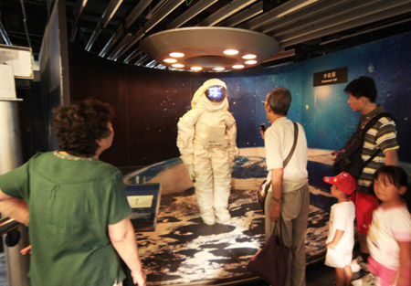 Visitors look around at the old exhibition hall of China Science and Technology Museum in Beijing, capital of China, on June 24, 2009. The Museum has been open to the public free of charge for 8 days from June 23 to July 1, as it will prepare for the opening of new site. 