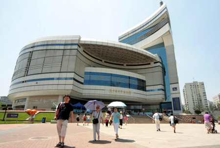 Visitors walk out of the old exhibition hall of China Science and Technology Museum in Beijing, capital of China, on June 24, 2009. 