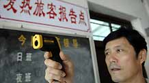 A worker tests a temperature monitor in the Xingang dock in Haikou, capital of south China's Hainan Province, on June 13, 2009.