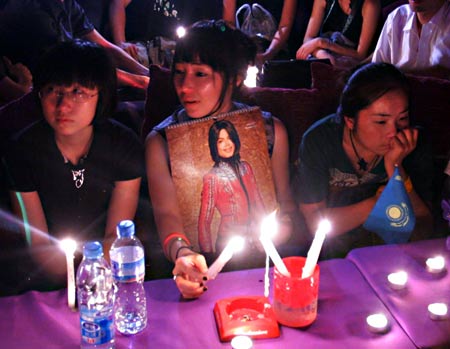 Chinese fans light candles as they attend a night gathering to mourn for the late U.S. megastar Michael Jackson, in Beijing, China, on June 26, 2009. The 50-year-old 'King of Pop' was pronounced dead on Thursday afternoon at the Medical Center of the University of California in Los Angeles, after he was in a full cardiac arrest.