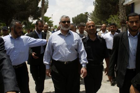 The deposed premier of Hamas administration in Gaza Ismail Haneya (C) is surrounded by his bodyguards during his visit to the Rafah border crossing in the southern Gaza Strip, on June 27, 2009. The Egyptian authorities reopened, partially, the Rafah crossing at the border with the Palestinian territory of Gaza Strip on Saturday for three days. 