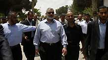 The deposed premier of Hamas administration in Gaza Ismail Haneya (C) is surrounded by his bodyguards during his visit to the Rafah border crossing in the southern Gaza Strip, on June 27, 2009. The Egyptian authorities reopened, partially, the Rafah crossing at the border with the Palestinian territory of Gaza Strip on Saturday for three days.