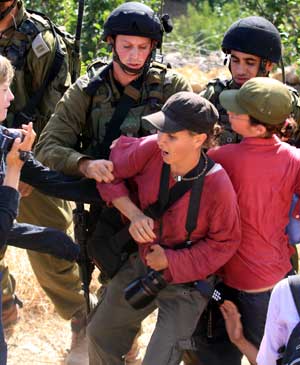 Israeli soldiers detain activists in the West Bank village of Safa near Hebron on June 27, 2009. At least 20 pro-Palestinian activists were detained Saturday during a demonstration which later became a scuffle against Jewish settlements in the West Bank villages near Hebron.