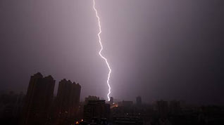 Lightning is seen over Wuhan, capital of central China's Hubei Province, as a thunderstorm hits the city on June 28, 2009.