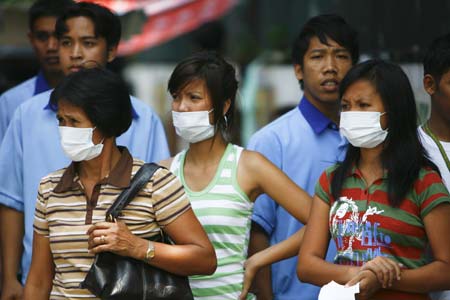 People wearing facial masks walk out of a hospital in Manila, capital of the Philippines, on June 29, 2009. The total number of confirmed cases of A/ H1N1 flu has risen to 604 in the Philippines as far as Sunday night, according to figures released by the Philippine Ministry of Health.