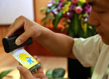 A working staff is demonstrating how to distinguish true World Expo tickets on June 29, 2009, in Shanghai.