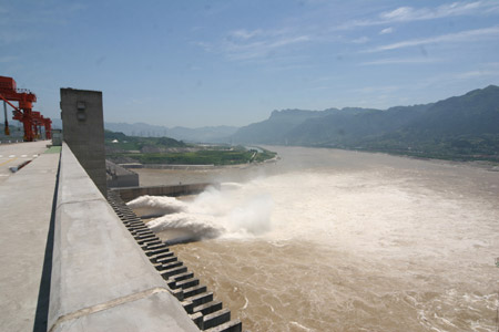 Photo taken on July 1, 2009 shows two deep-holes and a trash way hole opened for sluicing the mounting flood water on the Three Gorges Dam in Yichang, central China's Hubei Province.