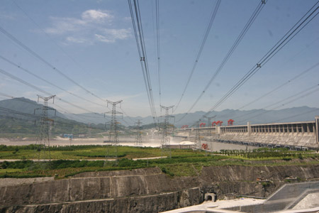 Photo taken on July 1, 2009 shows the power transmission lines at the Power Plant on the left bank of the three Gorges Dam, which opens two deep-holes and a trash way hole for sluicing the mounting flood water in Yichang, central China's Hubei Province. 