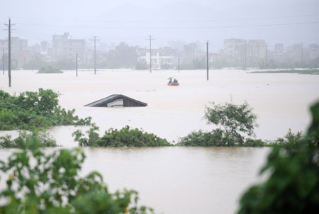 A rescue boat is seen in a flooded field in Rongshui County, southwest China's Guangxi Zhuang Autonomous Region, on July 4, 2009. Floods caused by rainstorms since early the week have left four people missing and 11,845 others displaced in Guangxi. The torrential rains have also damaged 12,440 hectares of crops and killed 53,300 heads of cattle. 