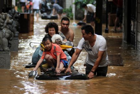 Local residents transfer to safe places on a handmade raft in the flood in Liuzhou, southwest China's Guangxi Zhuang Autonomous Region, on July 4, 2009. 