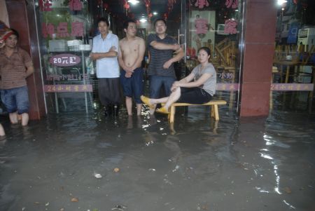 The local shoppers stray at the flooded grocery stores in downtown Yingtan City in south China's Jiangxi Province, on July 4, 2009. Heavy rain and storm struck the city saturday paralysing part of the city's communications.