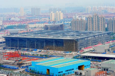 Photo taken on July 4, 2009 shows the Theme Pavilion under construction for the Shanghai 2010 World Expo in Shanghai, east China. The Shanghai 2010 World Expo is to open on May 1, 2010.