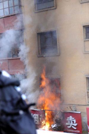 Photo taken on July 5, 2009 shows a shop being burned in a street of Urumqi, capital of northwest China's Xinjiang Uygur Autonomous Region.