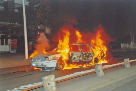 File photo released by the government of Urumqi City in a press conference in Urumqi, capital of northwest China's Xinjiang Uygur Autonomous Region, shows a burnt car in the riot happened on July 5, 2009.