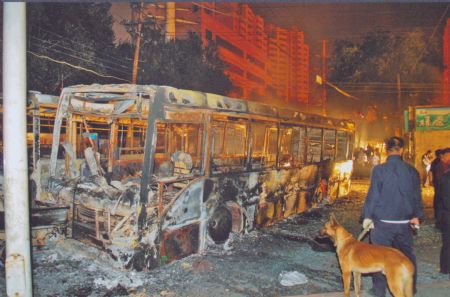 File photo released by the government of Urumqi City in a press conference in Urumqi, capital of northwest China's Xinjiang Uygur Autonomous Region, on July 7, 2009, shows a bus burnt in the riot. 