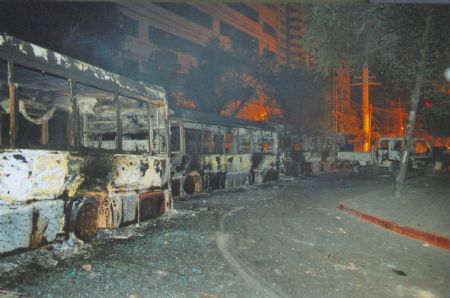 File photo released by the government of Urumqi City in a press conference in Urumqi, capital of northwest China's Xinjiang Uygur Autonomous Region, on July 7, 2009, shows vehicles burnt in the riot. 