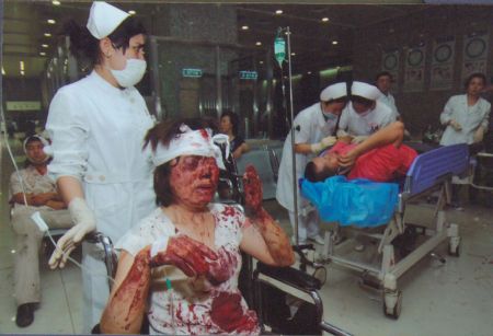 File photo released by the government of Urumqi City in a press conference in Urumqi, capital of northwest China's Xinjiang Uygur Autonomous Region, on July 7, 2009, shows medical workers take care of people injured in the riot happened on July 5, 2009. 