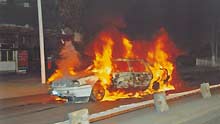 File photo released by the government of Urumqi City in a press conference in Urumqi, capital of northwest China's Xinjiang Uygur Autonomous Region, shows a burnt car in the riot happened on July 5, 2009.