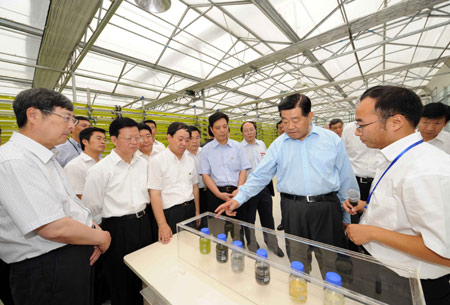 Jia Qinglin (2nd R Front), chairman of the National Committee of the Chinese People's Political Consultative Conference, visits XinAo Group, a private company specialized in research and development of renewable energy and new energy, during his inspection tour in Langfang, a city in north China's Hebei Province, on July 6, 2009.