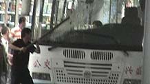 Photo released by police shows a rioter smashing a bus in Urumqi, capital of northwest China's Xinjiang Uygur Autonomous Region on July 5, 2009.