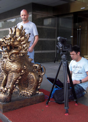 Reporters work outside a news center set up by local government in Urumqi, capital of northwest China's Xinjiang Uygur Autonomous Region, on July 8, 2009. 