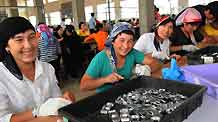 Xinjiang employees work at Xuri toy factory in Shaoguan City, south China's Guangdong Province, on July 7, 2009. More than 700 Xinjiang workers went back to work here on Tuesday after renovation of workshop, dormitory and dining-room. Their work had to be suspended after the fight between Uygur and Han ethnic workers at the toy factory on June 26.