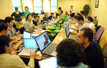 Chinese and foreign journalists work at the press center established at Hoi Tak Hotel in Urumqi, capital of northwest China's Xinjiang Uygur Autonomous Region, on July 7, 2009. More than 60 overseas media have sent journalists to Urumqi after a riot broke out in the city Sunday, leaving 156 people dead and 1,080 others injured.