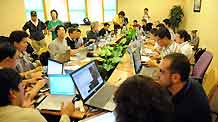 Chinese and foreign journalists work at the press center established at Hoi Tak Hotel in Urumqi, capital of northwest China's Xinjiang Uygur Autonomous Region, on July 7, 2009. More than 60 overseas media have sent journalists to Urumqi after a riot broke out in the city Sunday, leaving 156 people dead and 1,080 others injured.