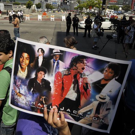 A fan holds a picture of Michael Jackson outside the Staples Center in Los Angeles on July 7, 2009. A star-studded public tribute to Michael Jackson was held here Tuesday with thousands of randomly selected fans joining family and friends to bid farewell to the King of Pop.