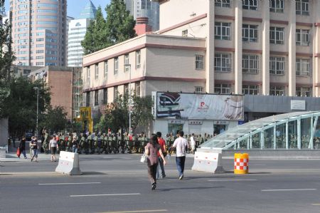 Armed police patrol on a road in Urumqi, capital of northwest China's Xinjiang Uygur Autonomous Region, on July 8, 2009. The city has lifted a traffic curfew on Wednesday morning, which began on 9:00 PM on Tuesday.