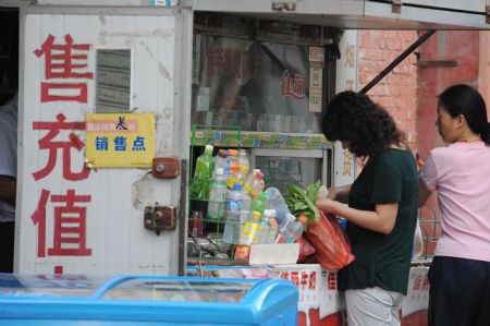 People buy groceries in Urumqi, capital of northwest China's Xinjiang Uygur Autonomous Region, on July 8, 2009.