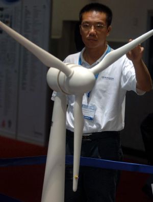 A visitor looks at the model of a generator on display during the 6th Asian Wind Energy Exhibition in Beijing, capital of China, on July 8, 2009. The exhibition, attended by 445 enterprises from 22 countries and regions, kicked off here Wednesday. 