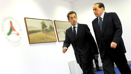 Italian Prime Minister Silvio Berlusconi (R) and French President Nicolas Sarkozy arrive at the main conference hall of the G8 summit in l'Aquila, Italy, on July 8, 2009. Leaders of the G8 industrialized countries began their summit on Wednesday, with the world economic crisis and climate change at the top of their three-day agenda.