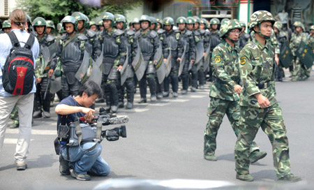 Overseas journalists work in Urumqi, capital of northwest China's Xinjiang Uygur Autonomous Region, on July 8, 2009.