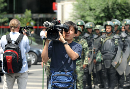 Overseas journalists work in Urumqi, capital of northwest China's Xinjiang Uygur Autonomous Region, on July 8, 2009.