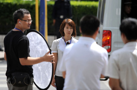 Journalists from south China's Hong Kong work in Urumqi, capital of northwest China's Xinjiang Uygur Autonomous Region, on July 8, 2009. 