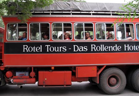 A bus carrying a group of German tourists leaves a hotel at Kuqa, northwest China's Xinjiang Uygur Autonomous Region, on July 10, 2009. 