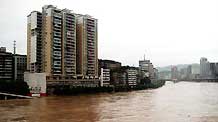 Photo taken on July 11, 2009 shows the flooded houses along the Binhe Road in Dazhou City, southwest China's Sichuan Province.