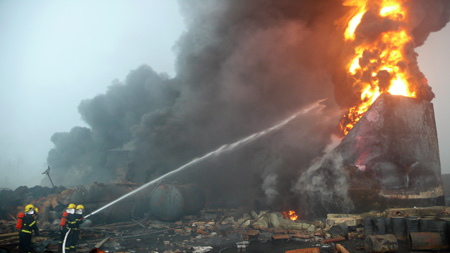 Firefighters spray water to put out fire at the Luoran chemical plant in Guxian Township of Yanshi City, central China's Henan Province, on July 15, 2009. A blast occurred at the Luoran chemical plant on early Wednesday morning, which was followed by a fire. The blast caused at least four people dead and 100 more others injured. The investigation of the accident was underway. 