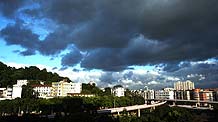 The sky is shrouded by dark clouds in Fuzhou city, capital of southeast China's Fujian Province, July 17, 2009. Molave, the sixth tropical storm this year, is moving towards the coast with a predicted landfall between central Guangdong Province in south China and south Fujian Province. The Fujian provincial observatory has issued the blue warning signal of typhoon on Friday.