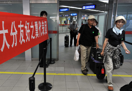 Residents of Japanese city of Oita walk out of the Tianhe Airport in Wuhan City, central China's Hubei Province, on July 18, 2009. A delegation, consisting of some 160 Oita citizens, arrived in Wuhan for their planned observation of the longest total solar eclipse of the 21st century, set to occur on July 22 over China. 