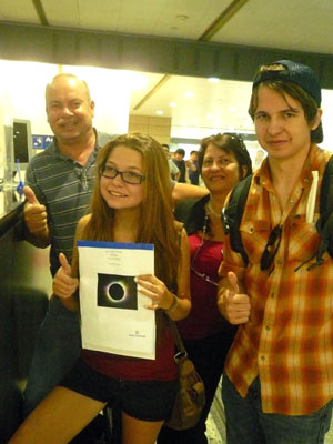 A family of astrophiles from Europe thumbs up upon their arrival at the Pudong Airport in Shanghai, east China, on July 18, 2009. The rising eclipse fever draws myriads of amateur stargazers from rest of the world to China for observation of the longest total solar eclipse of the 21st century, set to occur on July 22 over China.