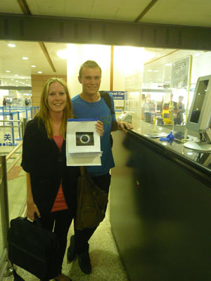 A pair astrophiles from Europe brings with a picture of solar eclipse while going through the custom formalities for entry upon their arrival at the Pudong Airport in Shanghai, east China, on July 18, 2009. The rising eclipse fever draws myriads of amateur stargazers from rest of the world to China for observation of the longest total solar eclipse of the 21st century, set to occur on July 22 over China. 