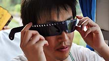 A resident of Japanese city of Oita shows his solar eclipse observing spectacle as he arrives in Wuhan City, central China's Hubei Province, on July 18, 2009. The delegation, consisting of some 160 Oita citizens, arrived in Wuhan for their planned observation of the longest total solar eclipse of the 21st century, set to occur on July 22 over China.