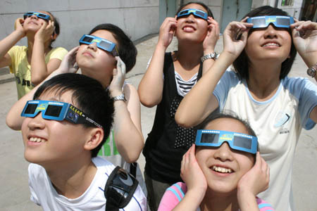Children simulate to view solar eclipse with goggles as a preparation for the coming one on July 22, in north China's Tianjin, on July 19, 2009. A total solar eclipse will be seen on July 22 in the area along the Yangtze River in central China, while a partial solar eclipse could be seen in Beijing, capital of China, and Tianjin.